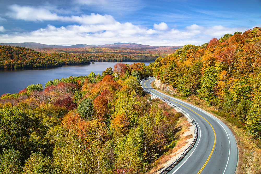The Old Canada Road Curves around the coloful hills along Wyman Lake in Central Maine